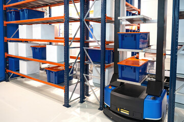 Poster - Automated warehouse equipment. Racks with plastic boxes. Autonomous warehouse cart. Innovations in logistics industry. Modern distribution center from inside. Autonomous warehouse without people