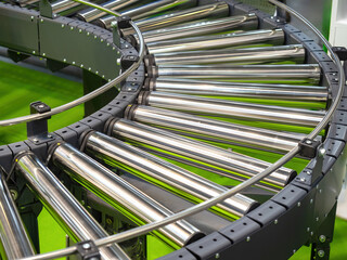 Poster - Fragment of conveyor around corner. Production technology. Conveyor inside factory building. Conveyor for automating production process. Equipment for accelerating manufacturing. Empty conveyor line