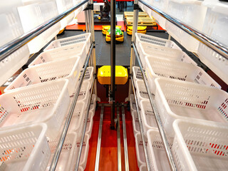 Poster - Warehouse technologies. Yellow autonomous mobile robot. Shelves with boxes in warehouse. AMR robots. AGV equipment. Sorting equipment in modern warehouse. AGV carts. Autonomous storage with robots