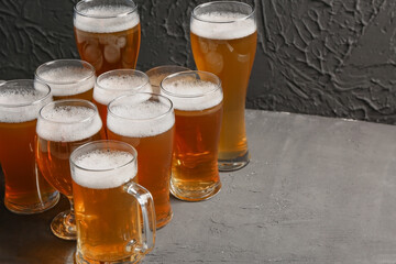 Glasses and mugs of cold beer on black background. Oktoberfest celebration