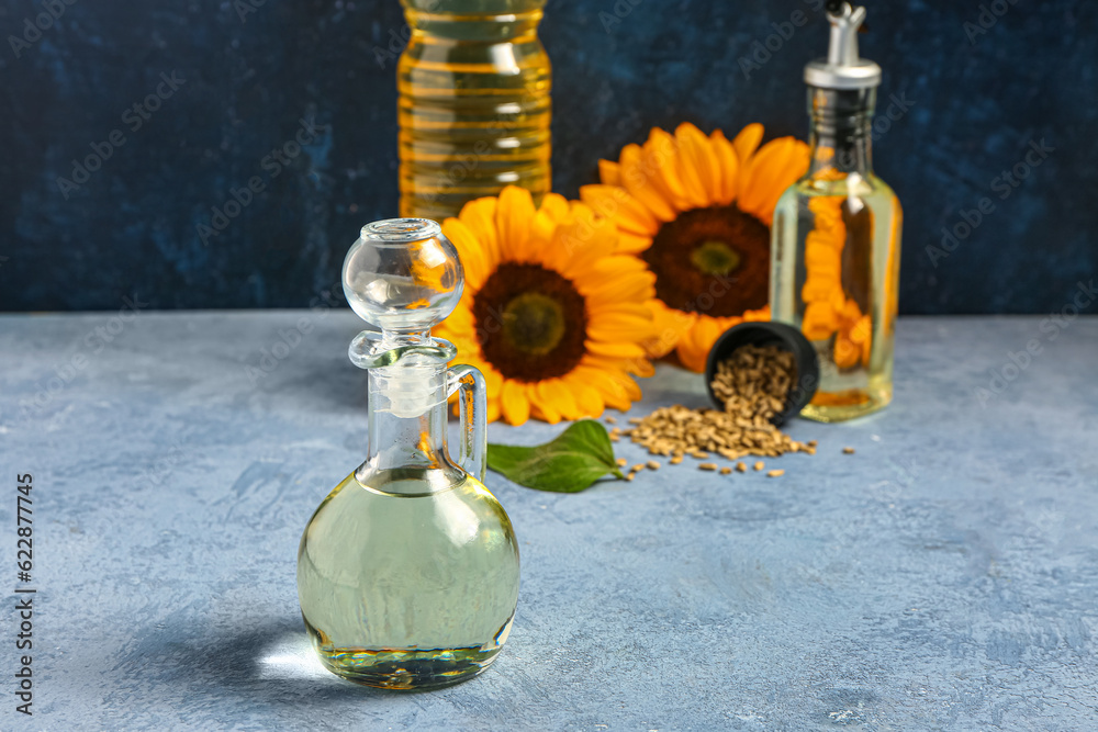 Decanter of sunflower oil on blue background