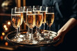 © alexkoral - tray with glasses of champagne in the hands of a waiter in a restaurant to celebrate a luxury party. Generative AI illustration