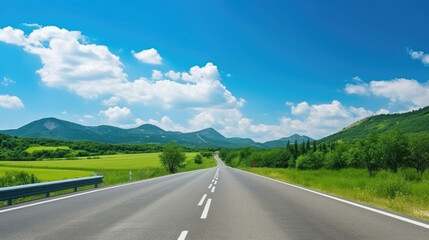 Canvas Print - Green mountain and empty asphalt highway natural scenery under the blue sky