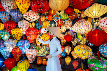 asian woman wearing vietnam culture traditional and hoi an lanterns at hoi an ancient town, vietnam.