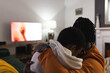 © Wavebreak Media - African american couple relaxing at home, scared, hugging, watching scary movie