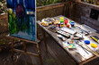 © Wavebreak Media - Close up of easel with painting and table with painting equipment on terrace