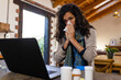 © Wavebreak Media - Biracial woman sitting at countertop, using laptop for medical consultation