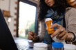 © Wavebreak Media - Biracial woman sitting at countertop, using laptop for medical consultation