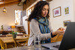 © Wavebreak Media - Biracial woman sitting at countertop, using laptop for medical consultation