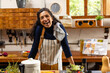 © Wavebreak Media - Portrait of happy biracial woman wearing apron cooking dinner in kitchen