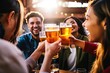 © Adriana - group of people cheering and drinking beer at bar pub table -Happy young friends enjoying happy hour at brewery restaurant-Youth culture-Life style food and beverage