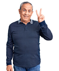 Wall Mural - Senior handsome man wearing casual polo showing and pointing up with fingers number two while smiling confident and happy.