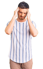 Poster - Handsome young man with bear wearing casual clothes suffering from headache desperate and stressed because pain and migraine. hands on head.