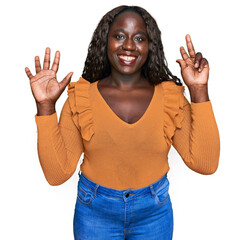 Canvas Print - Young african woman wearing casual clothes showing and pointing up with fingers number eight while smiling confident and happy.