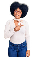 Sticker - Young african american girl wearing casual clothes and glasses pointing aside worried and nervous with forefinger, concerned and surprised expression