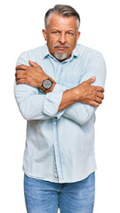 Poster - Middle age grey-haired man wearing casual clothes shaking and freezing for winter cold with sad and shock expression on face