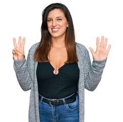 Sticker - Beautiful hispanic woman wearing casual clothes showing and pointing up with fingers number eight while smiling confident and happy.