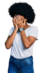 Poster - Young african american woman wearing casual white t shirt with sad expression covering face with hands while crying. depression concept.