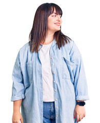 Poster - Young plus size woman wearing casual clothes looking away to side with smile on face, natural expression. laughing confident.