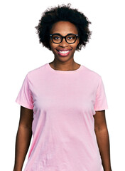 Poster - African american woman with afro hair wearing casual clothes and glasses with a happy and cool smile on face. lucky person.