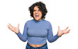 Leinwandbild Motiv Young hispanic woman with curly hair wearing casual clothes crazy and mad shouting and yelling with aggressive expression and arms raised. frustration concept.