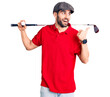 © Krakenimages.com - Young handsome man with beard playing golf holding club and ball pointing thumb up to the side smiling happy with open mouth