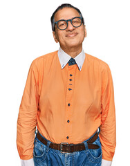 Sticker - Middle age indian man wearing casual clothes and glasses relaxed with serious expression on face. simple and natural looking at the camera.