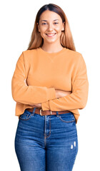 Wall Mural - Beautiful young woman wearing casual clothes happy face smiling with crossed arms looking at the camera. positive person.