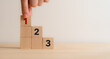 © Parradee - Task priority and management concept. The order of priority in any activity. Set work priority, arrange to do list. Wooden cube blocks with number first, second and third.