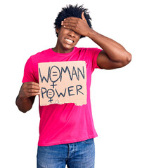 Poster - Handsome african american man with afro hair holding woman power banner stressed and frustrated with hand on head, surprised and angry face