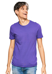 Poster - Young hispanic man wearing casual clothes looking away to side with smile on face, natural expression. laughing confident.