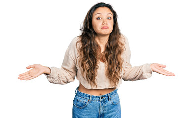 Young hispanic girl wearing casual clothes clueless and confused with open arms, no idea and doubtful face.