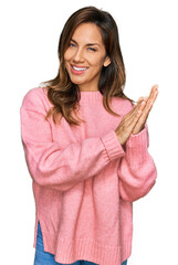 Wall Mural - Young hispanic woman wearing casual clothes clapping and applauding happy and joyful, smiling proud hands together