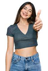 Wall Mural - Young beautiful teen girl wearing casual crop top t shirt smiling friendly offering handshake as greeting and welcoming. successful business.