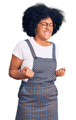 Poster - Young african american girl wearing casual clothes excited for success with arms raised and eyes closed celebrating victory smiling. winner concept.