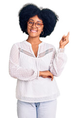 Wall Mural - Young african american girl wearing casual clothes smiling happy pointing with hand and finger to the side