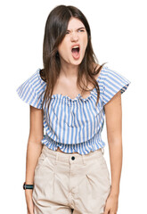 Wall Mural - Young beautiful caucasian girl wearing casual clothes angry and mad screaming frustrated and furious, shouting with anger. rage and aggressive concept.