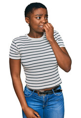 Canvas Print - Young african american woman wearing casual clothes looking stressed and nervous with hands on mouth biting nails. anxiety problem.