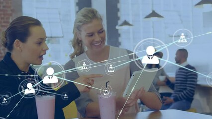 Poster - Animation of network of profile icons over two diverse women discussing over a tablet at a cafe