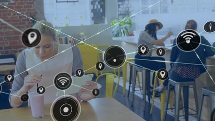 Poster - Animation of network of digital icons over caucasian woman drinking smoothie using tablet in a cafe