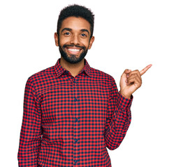 Sticker - Young african american man wearing casual clothes smiling happy pointing with hand and finger to the side