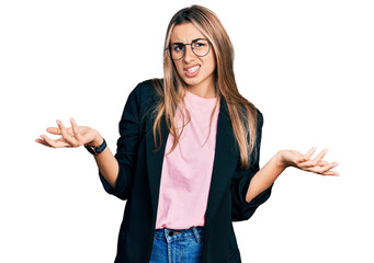 Poster - Hispanic young woman wearing business jacket and glasses clueless and confused with open arms, no idea concept.