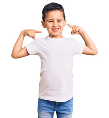 Wall Mural - Little cute boy kid wearing casual white tshirt looking confident with smile on face, pointing oneself with fingers proud and happy.