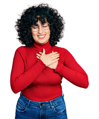 Poster - Young middle east girl wearing casual clothes and glasses smiling with hands on chest with closed eyes and grateful gesture on face. health concept.