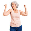 © Krakenimages.com - Senior grey-haired woman wearing casual clothes very happy and excited doing winner gesture with arms raised, smiling and screaming for success. celebration concept.