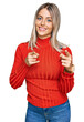 © Krakenimages.com - Beautiful blonde woman wearing casual clothes pointing fingers to camera with happy and funny face. good energy and vibes.