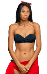 Wall Mural - Young african american woman wearing bikini depressed and worry for distress, crying angry and afraid. sad expression.