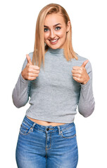 Wall Mural - Beautiful caucasian woman wearing casual clothes success sign doing positive gesture with hand, thumbs up smiling and happy. cheerful expression and winner gesture.