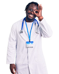 Poster - Young african american man with braids wearing doctor stethoscope and id pass smiling happy doing ok sign with hand on eye looking through fingers