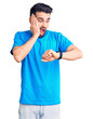 © Krakenimages.com - Young handsome man with beard wearing casual t-shirt looking at the watch time worried, afraid of getting late